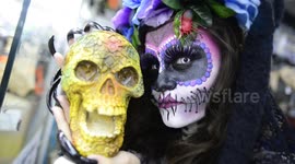 Woman in an impressive Mexican skull Halloween costume on the streets of Sao Paulo, Brazil