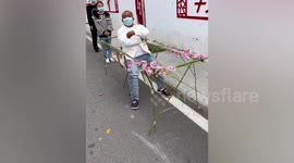 Man's unique chair helps distance himself from others in queue for COVID-19 test