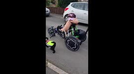 Little girl with Muscular dystrophy has her cute toy poodle dog runs by her side whilst she cycles in her specially adapted trike 6