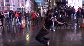 Wet pavement dancers dazzle crowds at Piccadilly Circus on Friday night