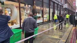 Workers clean windows after protesters defiled London's Harrods store