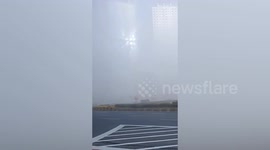 'Mysterious' spots of light shining through fog turn out to be from high-rise building windows