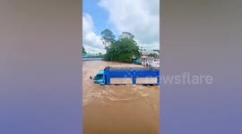 Truck battles through high floods swamping border market in Cambodia