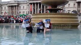 Animal Rebellion protesters climb into Trafalgar Square fountain with tofu and mock newspapers