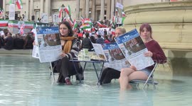 Animal Rebellion protesters sit in Trafalgar Square fountain with tofu and mock newspapers