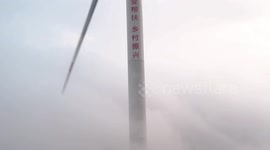 Drone Footage Of Wind Power Facilities Shrouded By Clouds On The Caowang Mountain, China