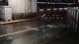 Heavy rain hits Stratford so much that water pours through the light fittings underneath the bridge that goes across Stratford Station.