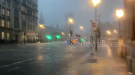 Sudden rain storm in Parliament Square, London