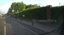 Child riding a bike hits a wall and falls over looking embarrassed
