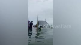 Twelve passengers delivering cash aid to islanders rescued from capsized pump boat in the Philippines