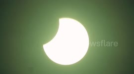 Plane flies across sun during partial solar eclipse spotted over London