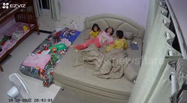 Affectionate kids tuck exhausted mum into bed