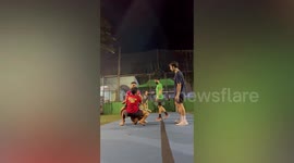Cheerleader falls to pavement after bases fail to catch her during stunt