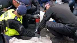 London police use machinery to cut free Just Stop Oil activists blocking road