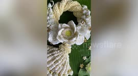 Thai vendor makes intricate flower garlands out of jasmine blossoms