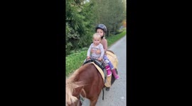 After taking care of their ponny, two little sisters enjoy some riding on him:)