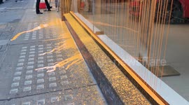 Exterior of Ferrari Mayfair after being sprayed with orange paint by Just Stop Oil