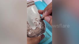 Thai artist hand paints amazing detailed designs on cups