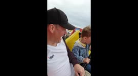 Father and son on fairground ride.
