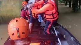Coast guard rescues pensioner and grandson as Typhoon Nalgae floods homes in the Philippines