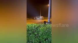 Two wild elephant bulls battle for territory on road in Thailand