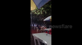 Diners unperturbed as Tropical Storm Nalgae batters coast in southern Philippines