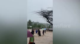 Road turns into raging river as Typhoon Nalgae kills 72 in the Philippines