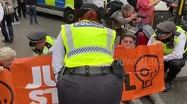 Eco-protesters Just Stop Oil block Charing Cross Rd near London's Leicester Square