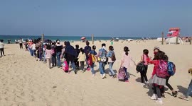 Palestinian children play on the beach in Gaza City during a psychological support event