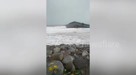 Barge runs aground leaving one missing as Tropical Storm Nalgae churns up large waves in the Philippines