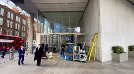 Workers clean windows after a Just Stop Oil supporter painted orange paint on Rupert Murdoch News UK's London headquarters, owner of The Sun, The Times, The Sunday Times, Talk Radio and Talk TV on London Bridge.