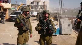 Israeli bulldozers demolish a three-storey Palestinian building