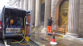 Workers clean Bank of England up of orange paint from Just Stop Oil protest