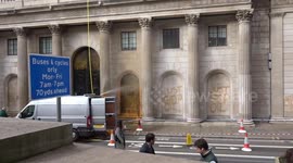 The Bank of England is cleaned up of orange paint following Just Stop Oil spray attack - London