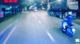 Lucky rider regains balance when tailing car hits him from behind