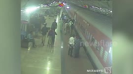 Platform guard's vigilance helps save life of female passenger who slipped and fell while boarding train in northern India