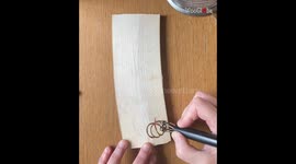 Talented pyrographer embraces autumn by woodburning a fresh broomstick/pumpkins design