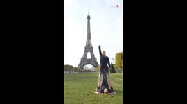 Acrobat helps his partner nail a SICK side flip in front of Eiffel Tower
