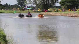 Locals compete in amusing boat race at Buddhist ceremony in Thailand