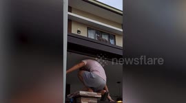 Cat lover husband climbs roof to save stubborn kitten