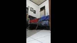 The guy, instead of sports equipment, uses his bed for training!