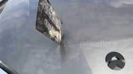Watch moment steel plate flies into car bonnet on Chinese highway
