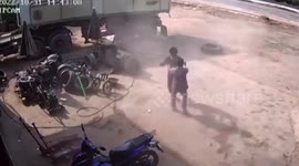 Overinflated truck tire explodes in garage worker's face