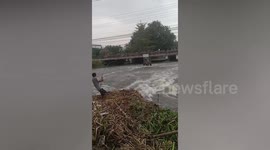 Villager goes fishing on water hyacinth raft in Thailand