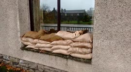 People deploy sandbags to protect against flooding in Cumbria, UK