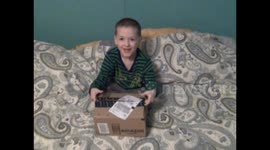 Young Boy Opening A Package