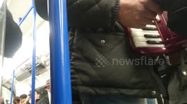 Impromptu Jingle Bells performance on London tube