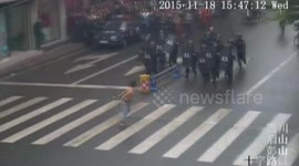 Topless man armed with knives confronts riot police