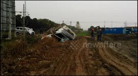 Concrete mixer turns over on collapsed road after parking