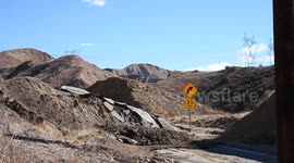 Landslide buckles road in California V19285